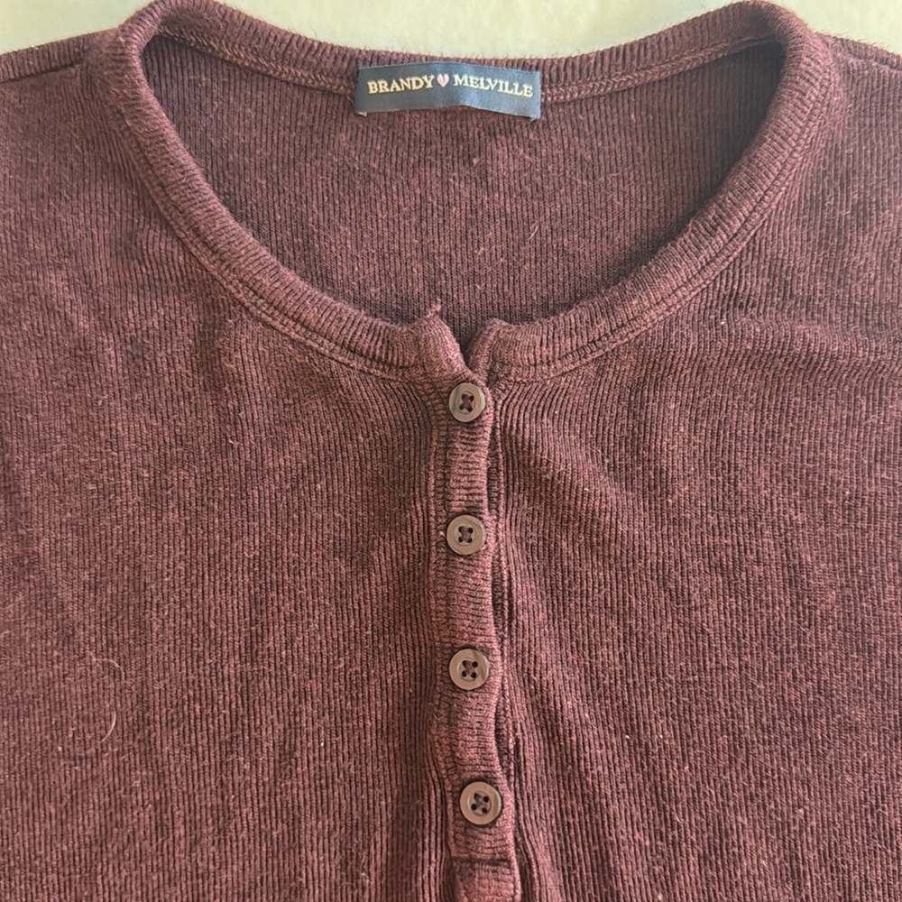 A dark red long sleeve Brandy Melville shirt.